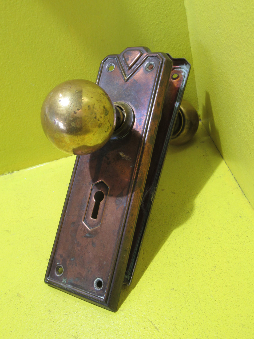 Art Deco Copper Plate with Raised Edge & Diamond Detail at the Top completed with Brass Ball Handles.   Plate 187L x 61W  Handle 45 Dia x 60H